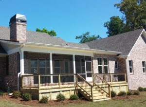 Seamless gutters installed over rear deck