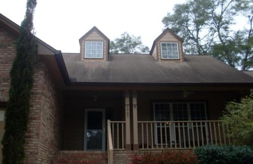 Brown color matched gutters installed on front of house